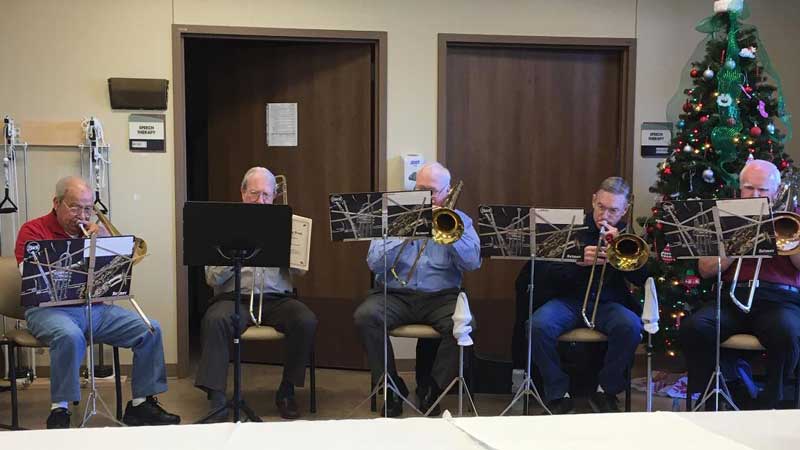 Jim Ruiz playing trombone at hospital